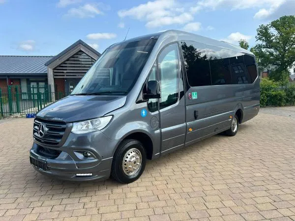A grey Mercedes Sprinter minibus